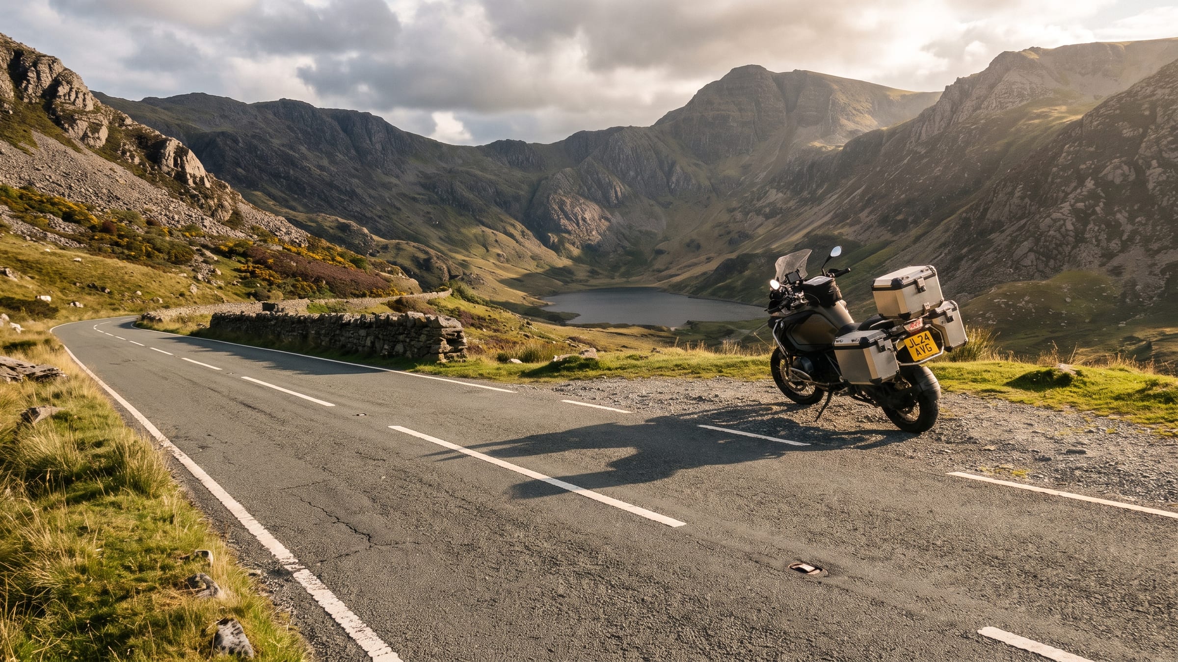 A mountain road climbing through a Snowdonia valley